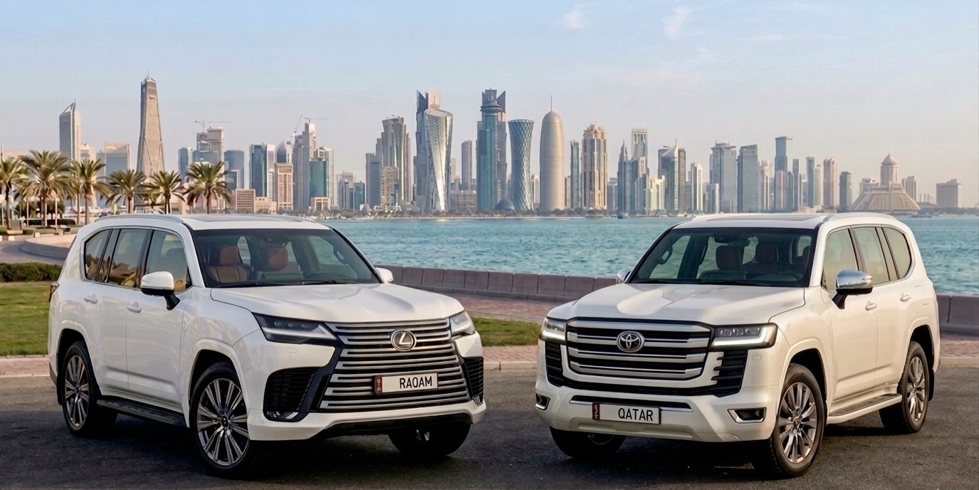 Two SUVs with Qatari licence plates in front of the Doha skyline